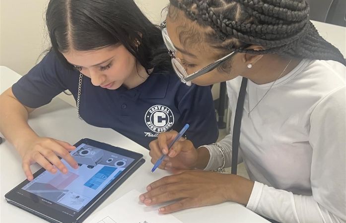   Two girls working on the iPad.