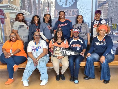 staff posing with tigers gear