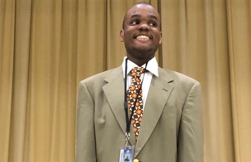Student Smiling with a Suit on