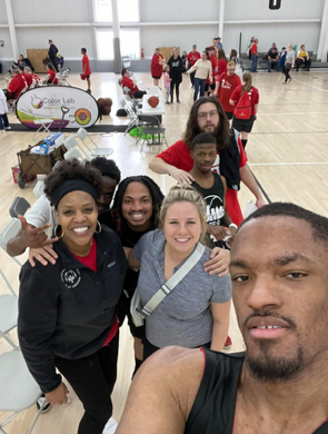 students and staff posing at basketball game