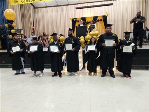  Drew students standing with certificates