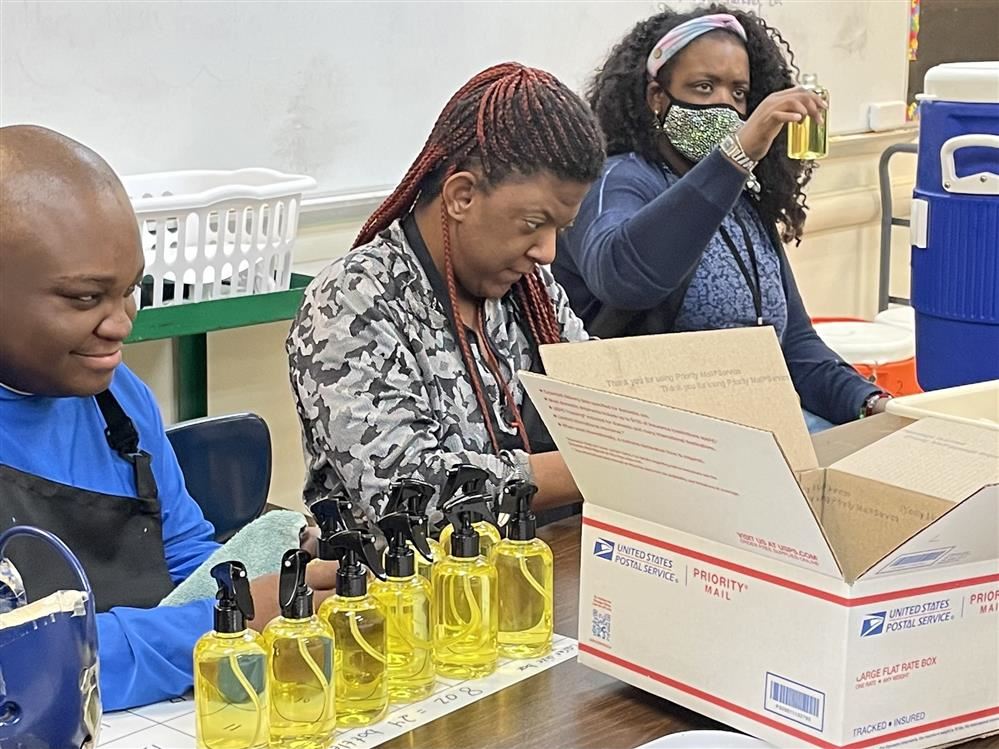  Students putting oil into bottels