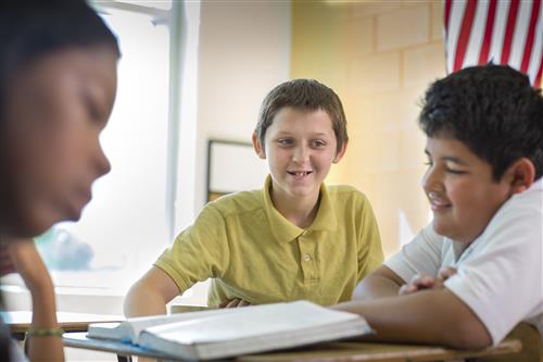 Students working together in a classroom Students working together in a classroom