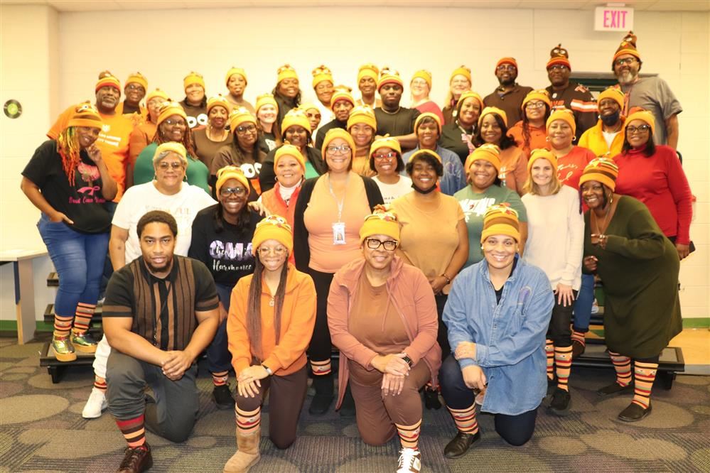  Staff of Charles Wright Academy posing in their matching turkey hats and socks