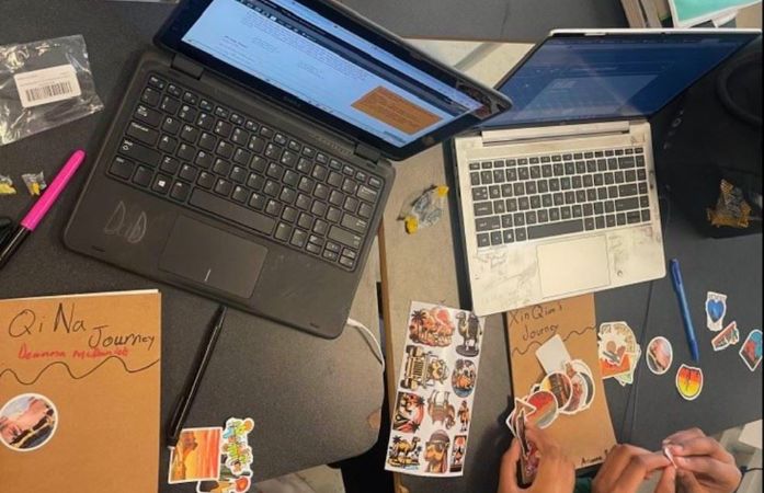   Students using stickers to decorate their silk road journals