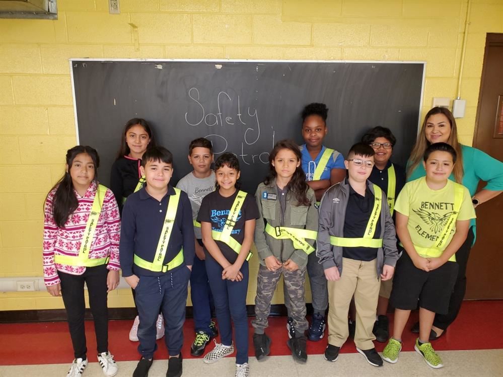 Several children and one adult posing for a picture