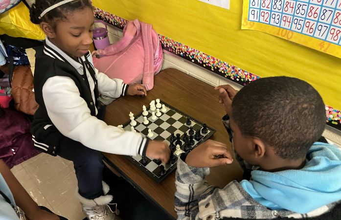  Two 3rd grade students playing a game of chess
