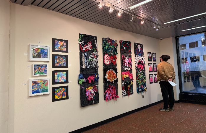 Chrysler's Art Teacher looking at the artworks in the WWCD Gallery