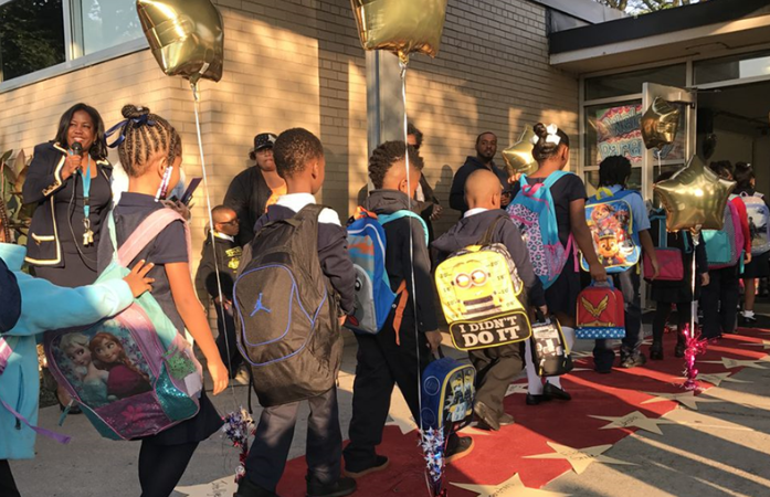  Students walking on the red carpet into Chrysler Elementary
