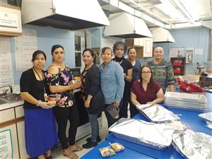 Parents and school staff helping prepare luncheon 