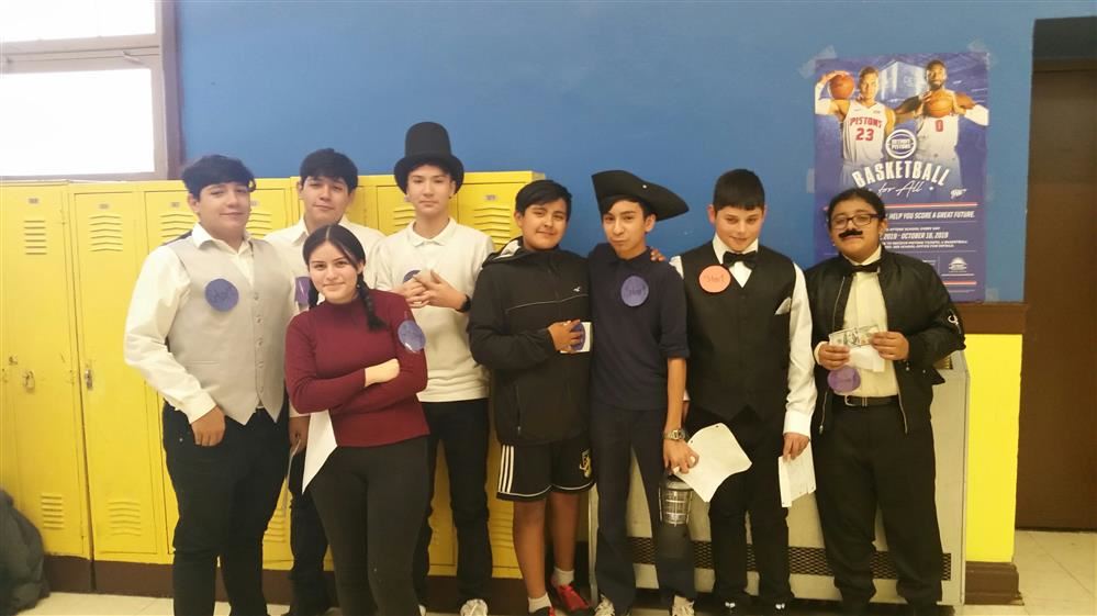 a group of students standing in front of lockers in costume for living history night