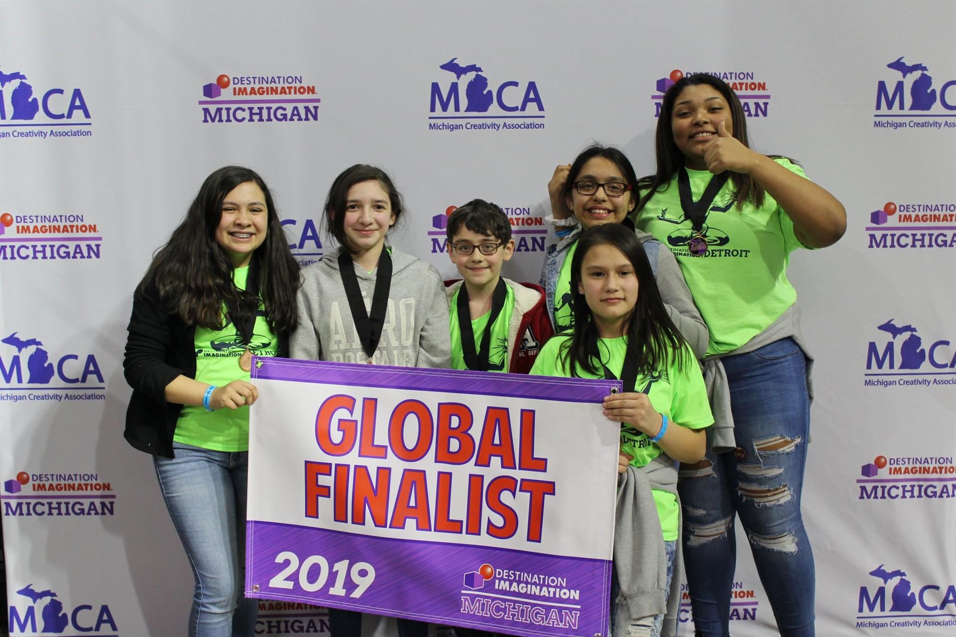 The Dream Team holding their Global Finalist 2019 Banner. 