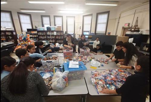 students helping make treat bags 