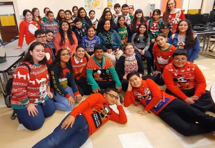  students and staff wearing their "ugly" holiday sweaters