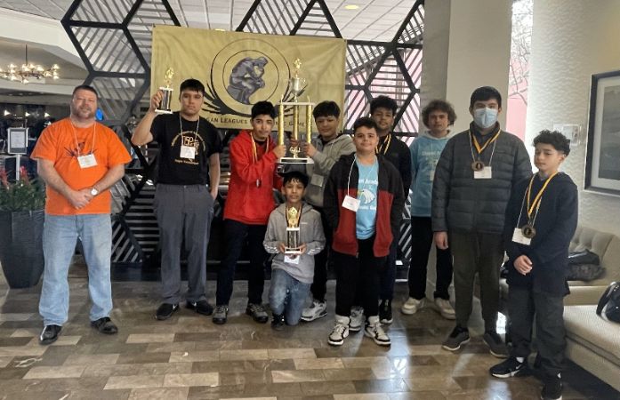  academic games students and their coach with their trophies
