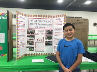 Jonathan Perez and his "What conditions affect the growth of algae?" science fair project board. 
