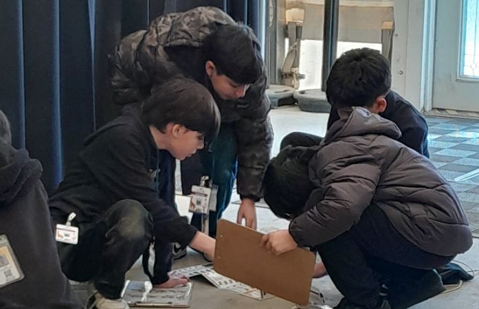  students examining bones