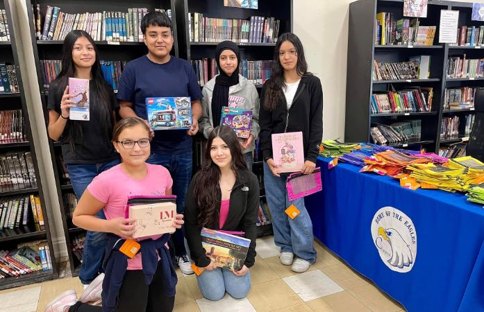  students holding prizes in school library