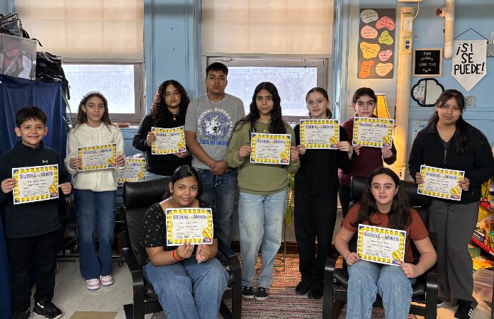  a group of students standing and some sitting with certificates