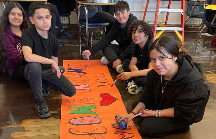  students working on a poster