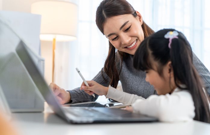  Mother and daughter working on a laptop