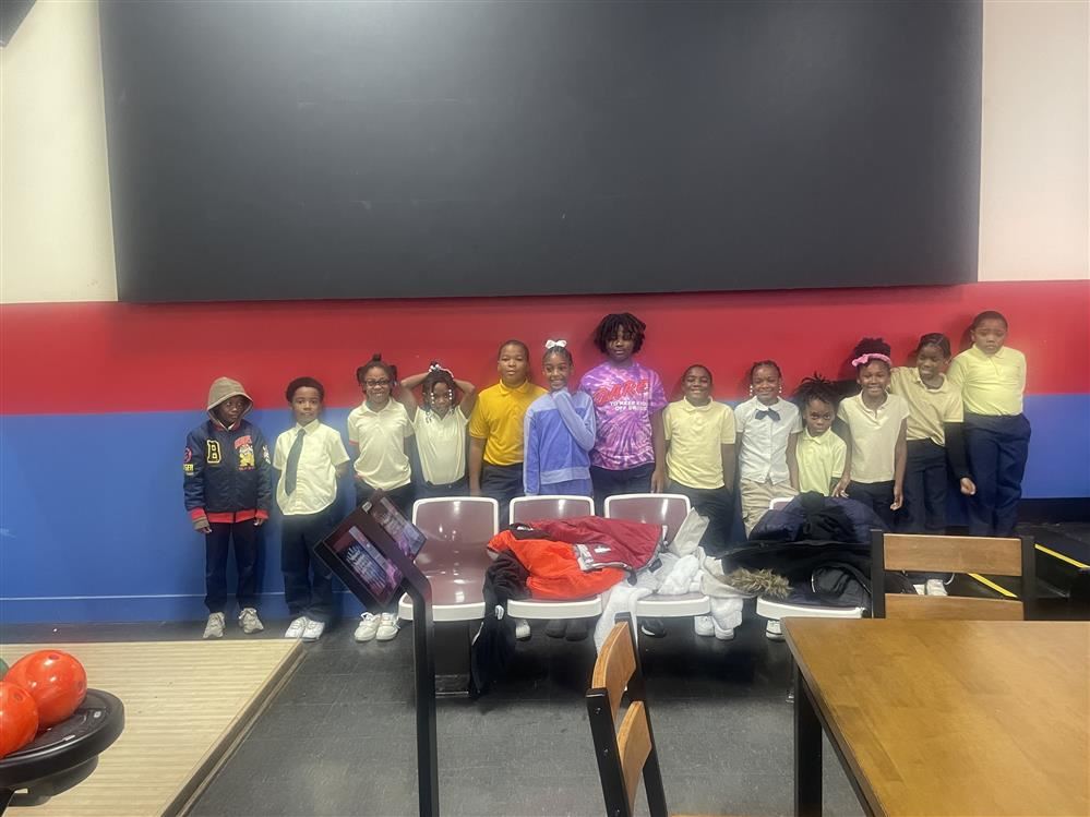group of students standing in a line in a bowling alley