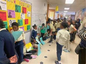 many students in the hall sharing work.