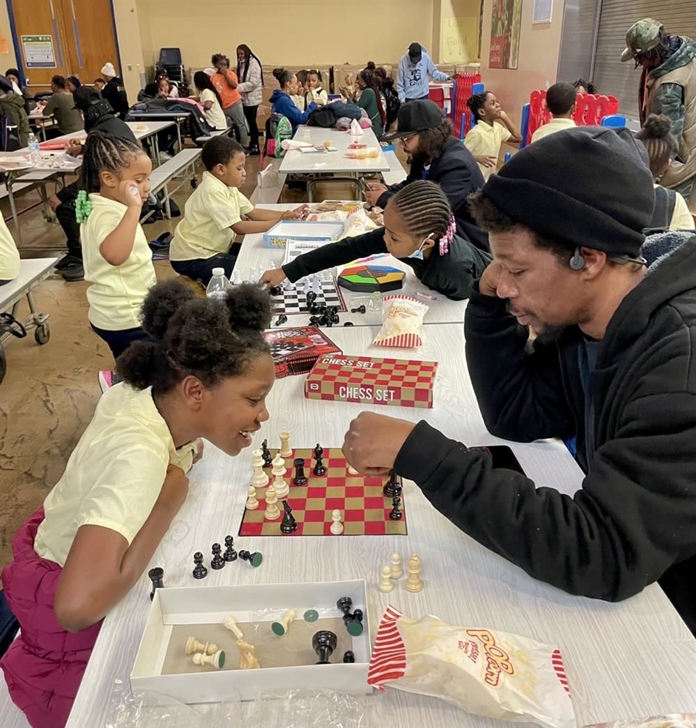 father and daughter playing chess