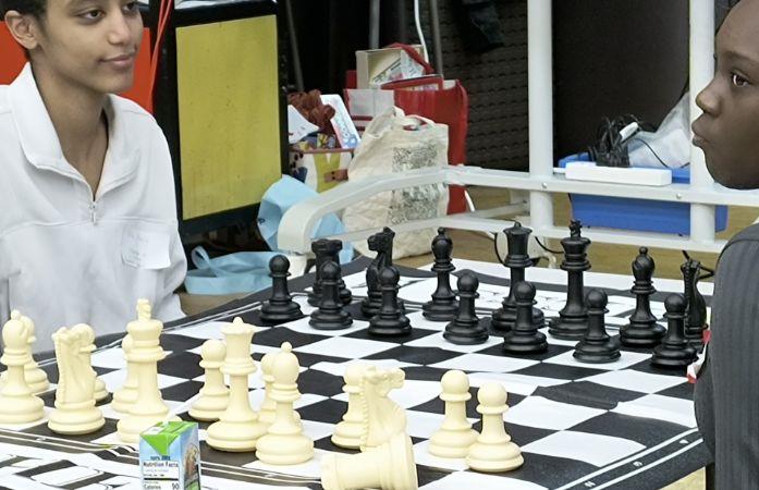 two students playing chess