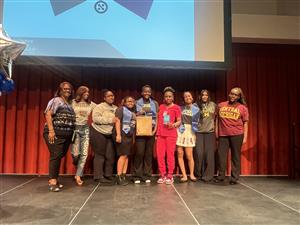 Students on stage accept award