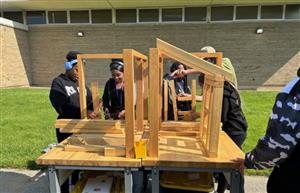 Students building wood structures 