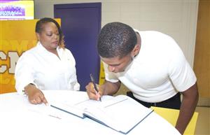Student signing National Honor Society Book