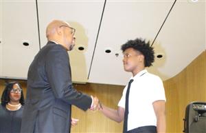 Student shaking hands with teacher