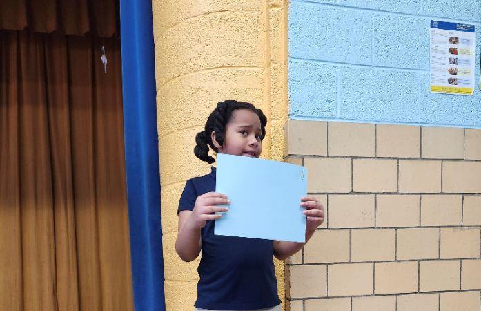 Student holding up a certificate
