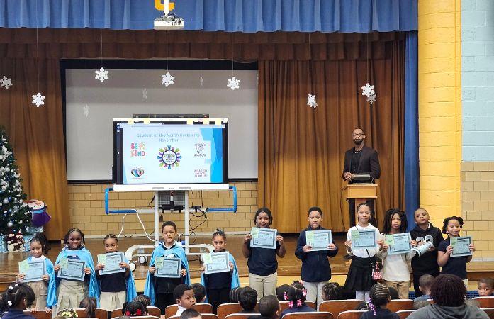 11 Students holding up their certificate