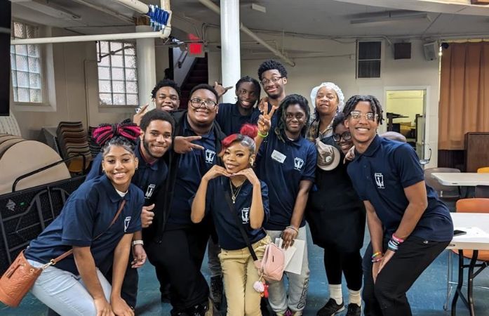  students posing together at the Soup Kitchen