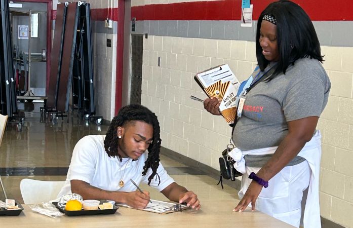  student filling out voter registration application