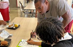 volunteer explaining the voter registration application