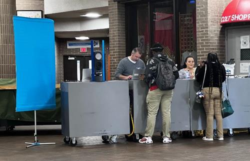 2 students at Mobile Unit desk receiving services