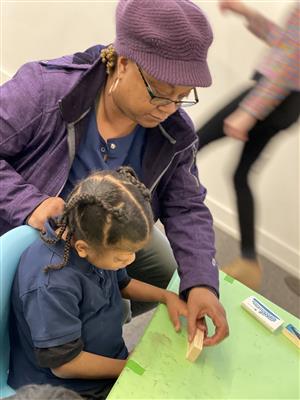 Student and teacher working on a project togehter