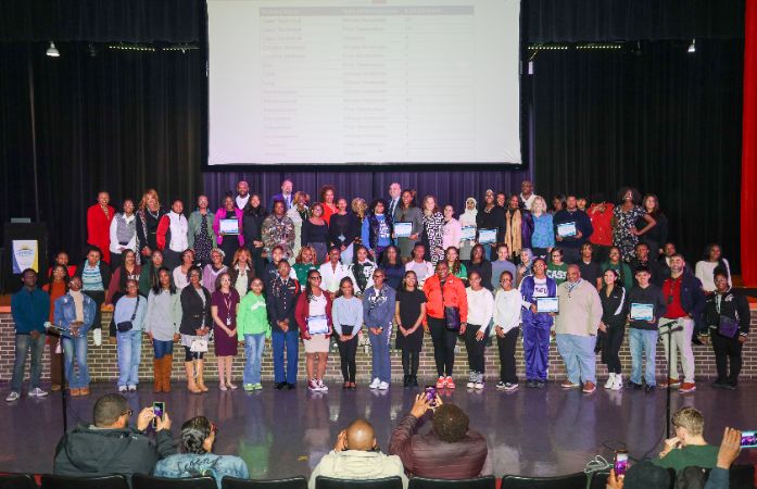  student awardees on stage at the board meeting
