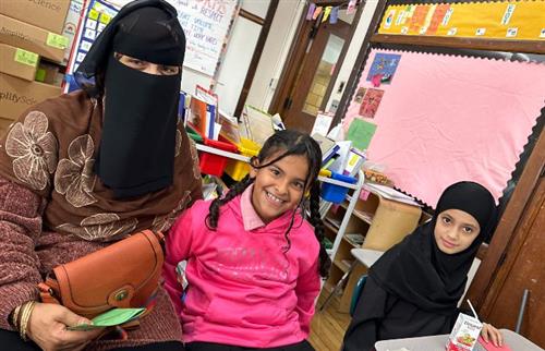 Mother and daughters in classroom