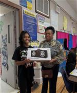  A teacher giving a student a gift 