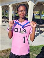 student holding a medal
