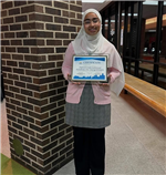  student holding award 