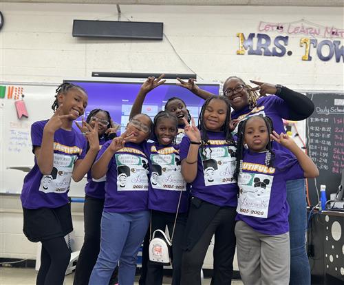 Beautiful U students posing for a picture with Mrs. Townsel.