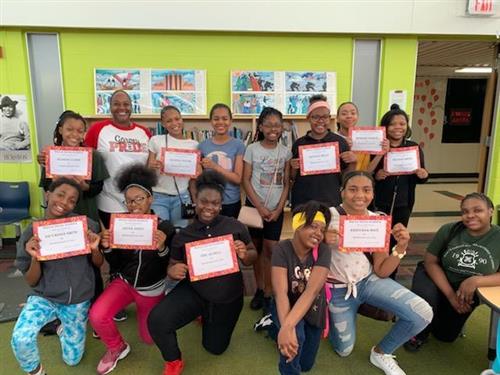 Students holding up certificates