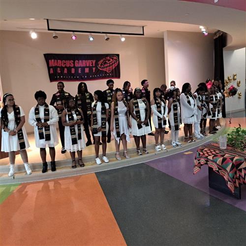 Students on stage with graduation stoles