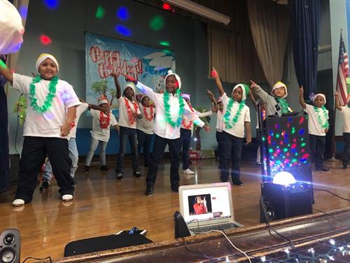 Students dancing on stage for the program.