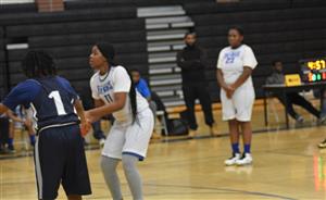 A young lady focuses while shooting a free throw